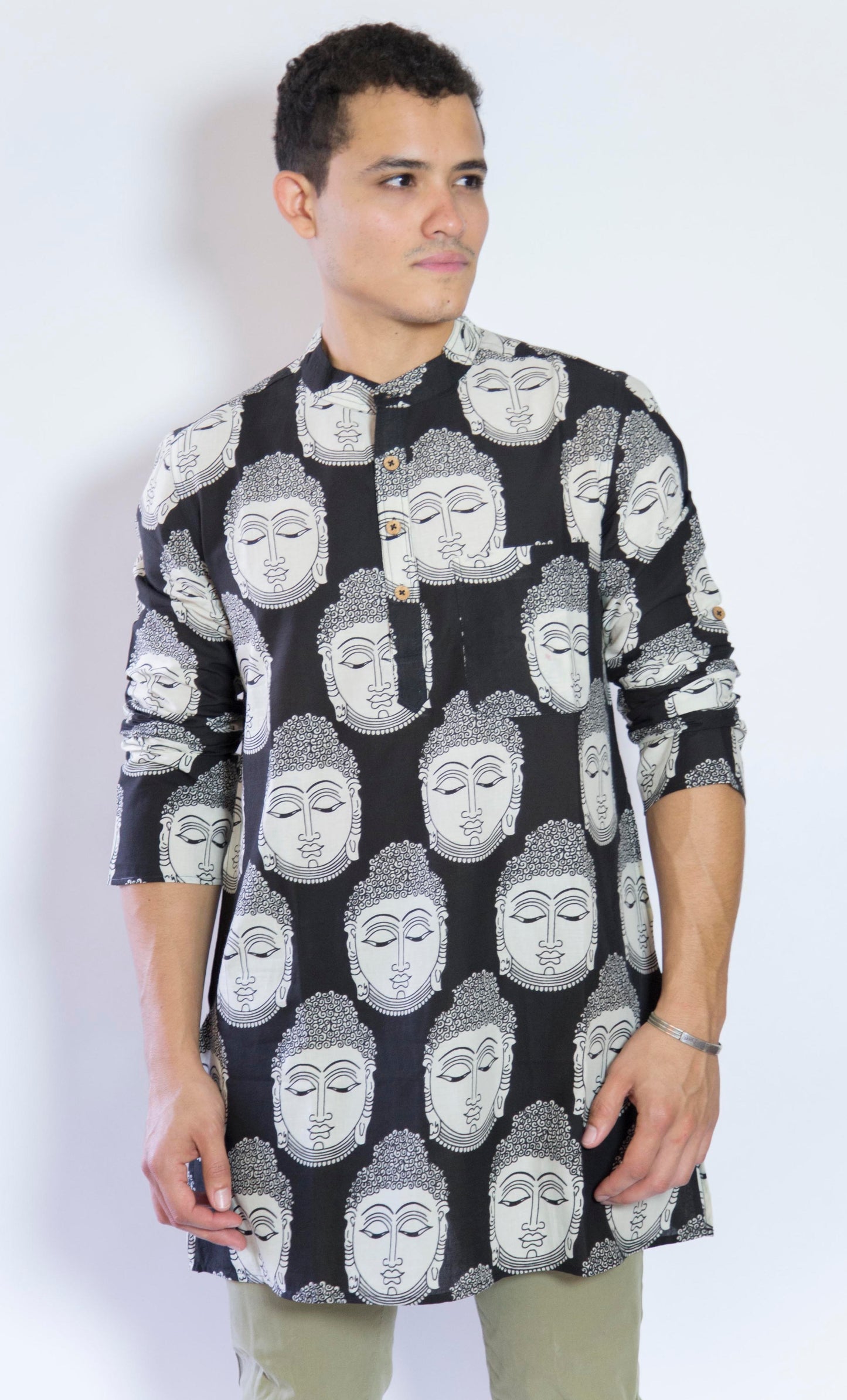 Quiet and Still. The Buddha in Black. This loose fitting and airy Kurta pairs well with some chinos and desert boots. Long sleeves to be kept stretched out or rolled up in place with wooden buttons on the elbows to maintain that cool and casual vibe. 100% Cotton Chest and Side Pockets Regular Fit Made in India