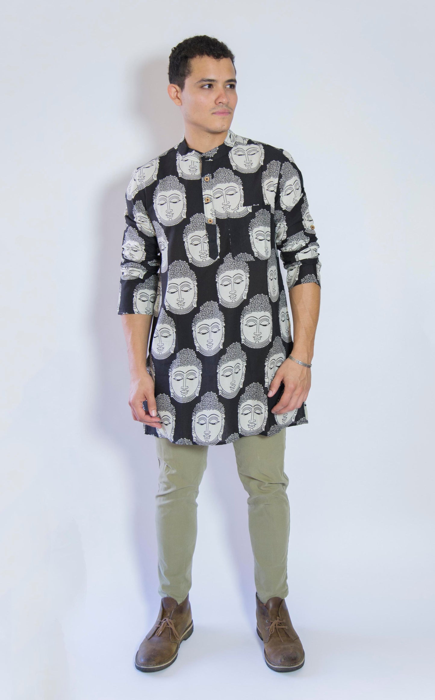 Quiet and Still. The Buddha in Black. This loose fitting and airy Kurta pairs well with some chinos and desert boots. Long sleeves to be kept stretched out or rolled up in place with wooden buttons on the elbows to maintain that cool and casual vibe. 100% Cotton Chest and Side Pockets Regular Fit Made in India