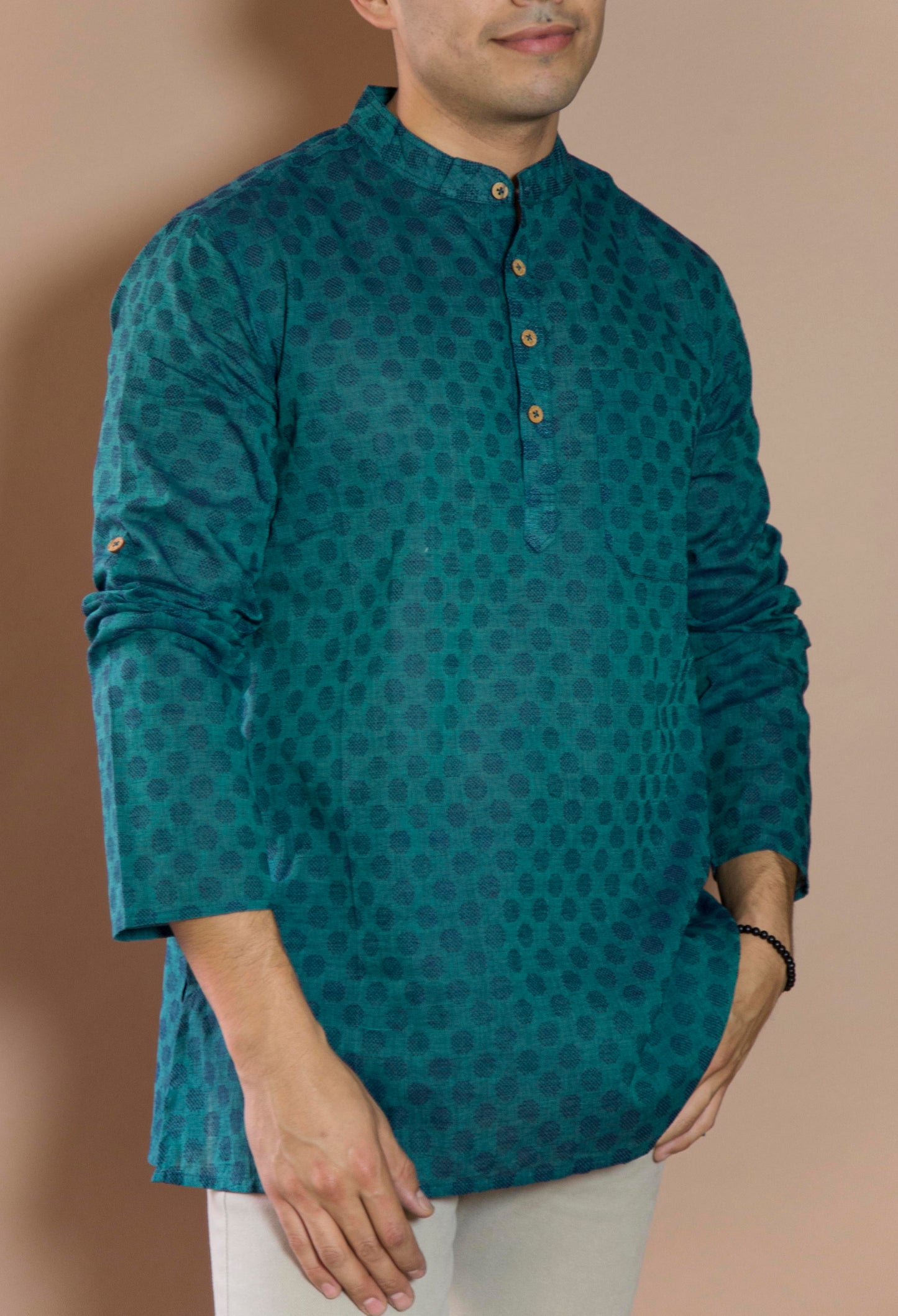 Teal Oval Pleasant & Serene The Teal Oval Kurta. This loose fitting and airy Kurta pairs well with some jeans or chinos and boots or sneakers. Long sleeves to be kept stretched out or rolled up in place with wooden buttons on the elbows to maintain that cool and casual vibe. 100% Cotton Chest and Side Pockets Regular Fit Made in India