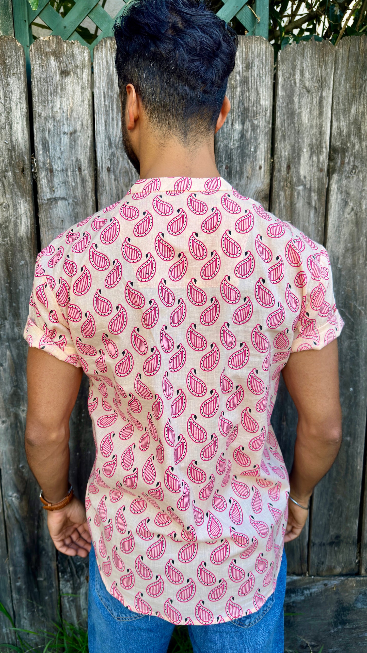 Paisley | Kurta | Band Collar Men's Shirts Quarter Button Cotton. Showcasing the signature South Asian Band Collar neck coupled with coconut button enclosures; The Kurta effortlessly blends Eastern aesthetics with Western style. Quarter button, pink paisley print. A shirt designed to be a South Asian inspired elevated casual cotton shirt. 