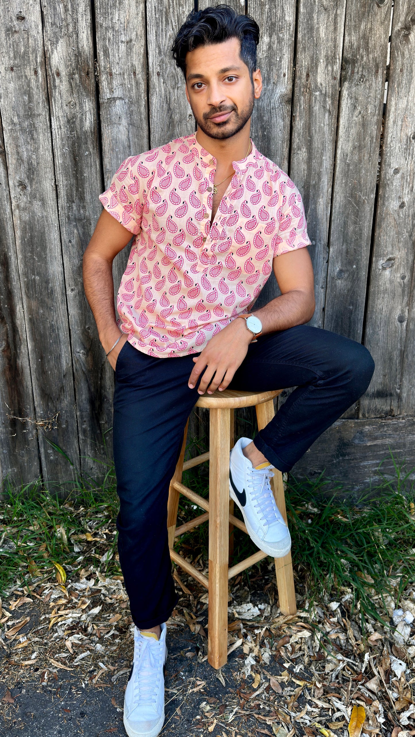 Paisley | Kurta | Band Collar Men's Shirts Quarter Button Cotton. Showcasing the signature South Asian Band Collar neck coupled with coconut button enclosures; The Kurta effortlessly blends Eastern aesthetics with Western style. Quarter button, pink paisley print. A shirt designed to be a South Asian inspired elevated casual cotton shirt. 