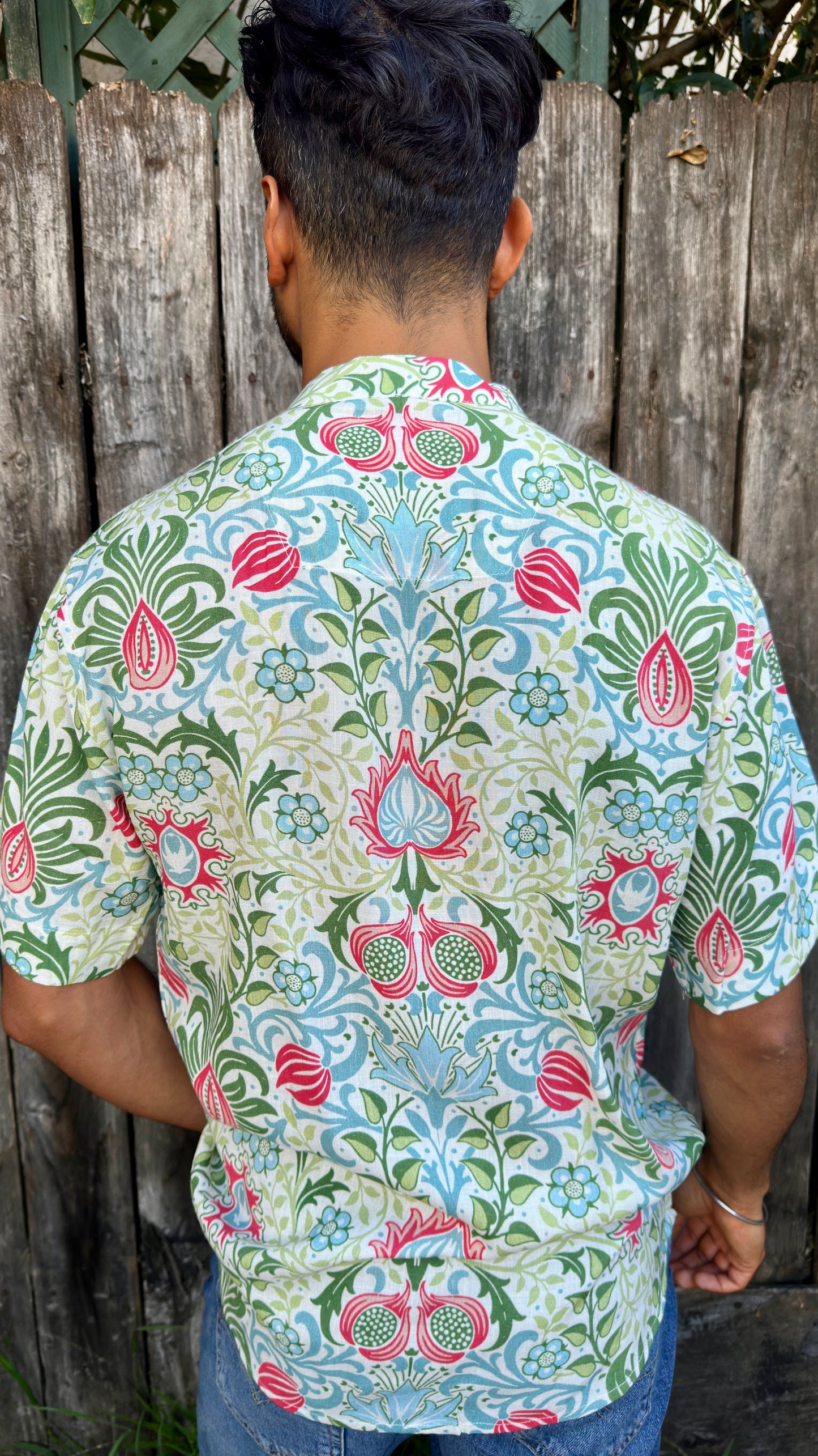 Inspired by the cool, easy Cuban Collar shirt. The Ranjha grounds itself in its South Asian roots with the Band Collar neck paired alongside a V-cut in the middle to maintain the Cuban Collar swag. Full button men's shirt. Floral print. A shirt designed to be a South Asian  inspired elevated casual rayon shirt. Taj | Band Collar Men's Shirts | Short Sleeve Floral Print V-Cut Rayon