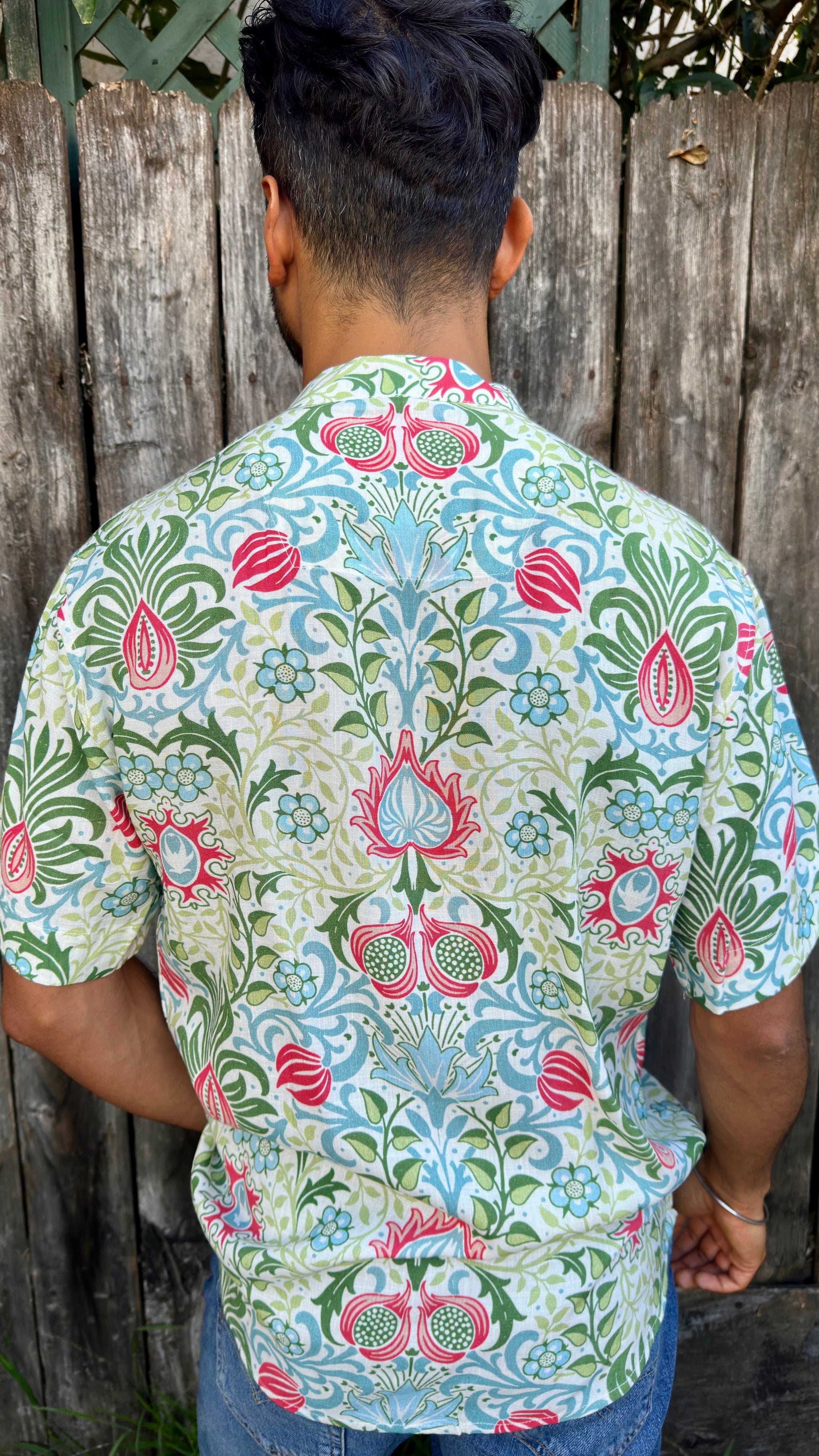 Inspired by the cool, easy Cuban Collar shirt. The Ranjha grounds itself in its South Asian roots with the Band Collar neck paired alongside a V-cut in the middle to maintain the Cuban Collar swag. Full button men's shirt. Floral print. A shirt designed to be a South Asian  inspired elevated casual rayon shirt. Taj | Band Collar Men's Shirts | Short Sleeve Floral Print V-Cut Rayon