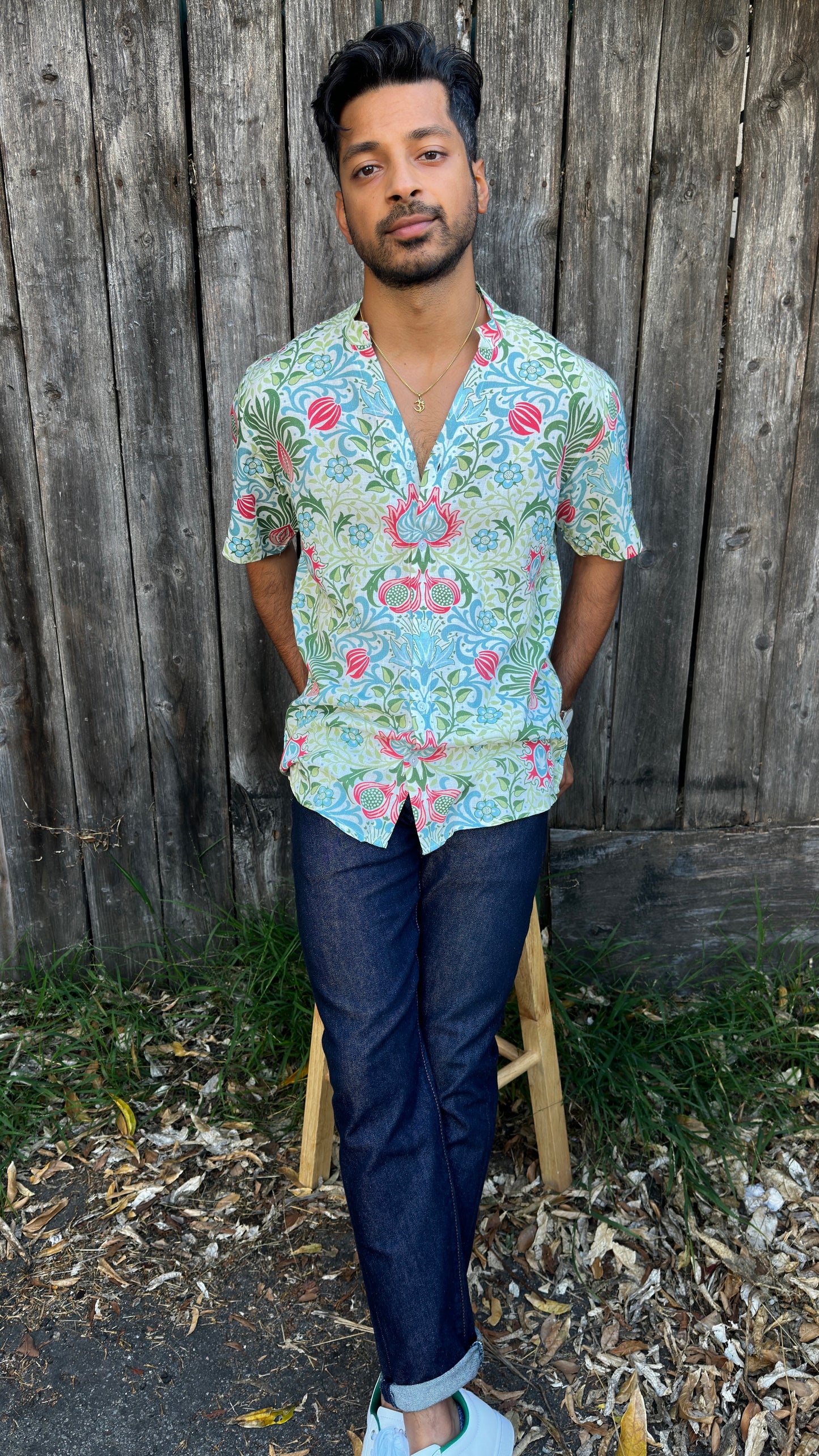 Inspired by the cool, easy Cuban Collar shirt. The Ranjha grounds itself in its South Asian roots with the Band Collar neck paired alongside a V-cut in the middle to maintain the Cuban Collar swag. Full button men's shirt. Floral print. A shirt designed to be a South Asian  inspired elevated casual rayon shirt. Taj | Band Collar Men's Shirts | Short Sleeve Floral Print V-Cut Rayon