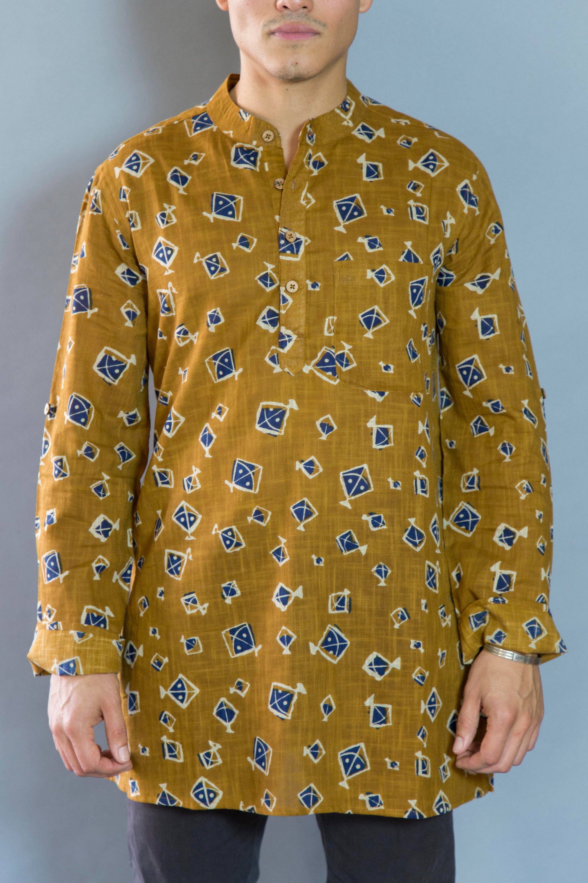 Kite Eccentric & Airy The Kite Kurta. This loose fitting and airy Kurta pairs well with some jeans or chinos and boots or sneakers. Long sleeves to be kept stretched out or rolled up in place with wooden buttons on the elbows to maintain that cool and casual vibe.   100% Cotton  Chest and Side Pockets  Regular Fit Made in India